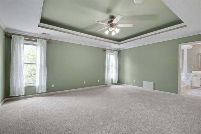 6330 N Nevada Ave, Parkville, MO 64152 - carpeted empty room with a tray ceiling, ornamental molding, a ceiling fan, and baseboards
