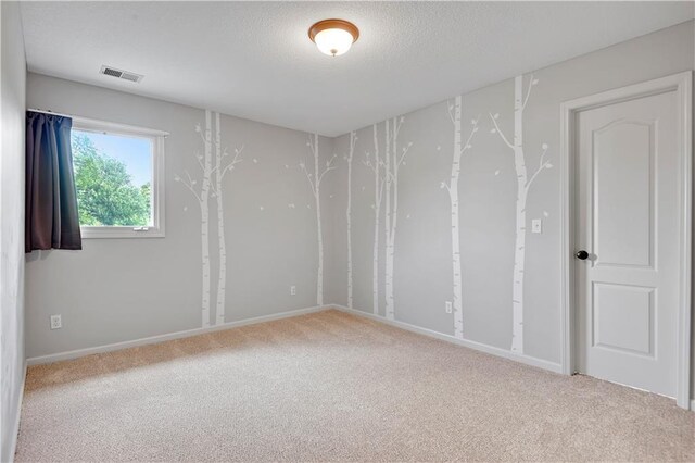 6330 N Nevada Ave, Parkville, MO 64152 - unfurnished room featuring carpet flooring, a textured ceiling, and baseboards