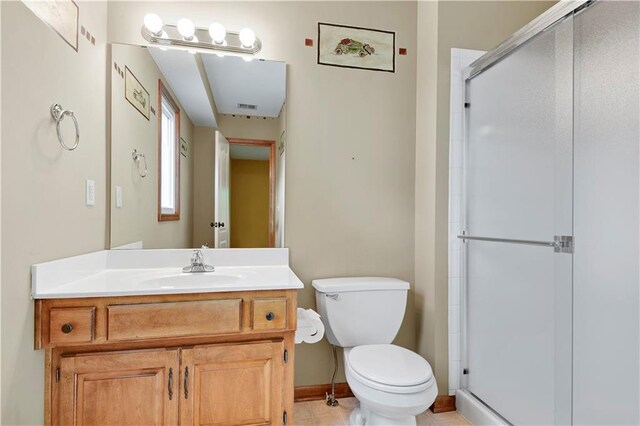 6330 N Nevada Ave, Parkville, MO 64152 - bathroom featuring toilet, vanity, a shower stall, and baseboards