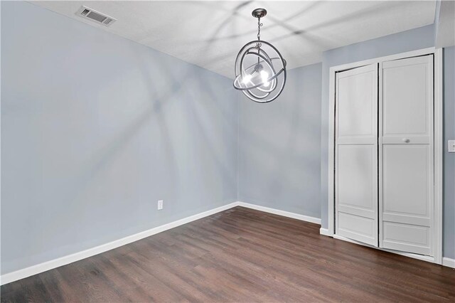 6330 N Nevada Ave, Parkville, MO 64152 - unfurnished dining area featuring dark wood-type flooring and baseboards