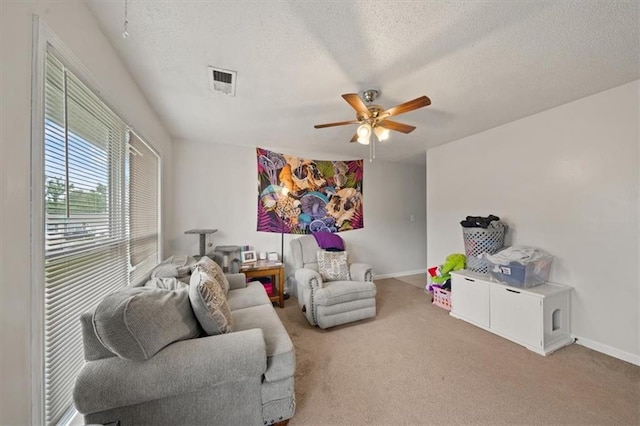18828-30 E Wigwam Pl, Independence, MO 64056 - living area featuring a textured ceiling, carpet, a ceiling fan, and baseboards