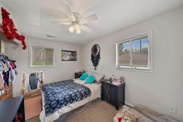 18828-30 E Wigwam Pl, Independence, MO 64056 - carpeted bedroom with a textured ceiling, ceiling fan, and baseboards