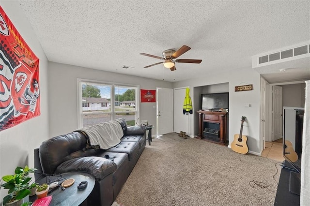 18828-30 E Wigwam Pl, Independence, MO 64056 - carpeted living area with a ceiling fan, a fireplace, and a textured ceiling