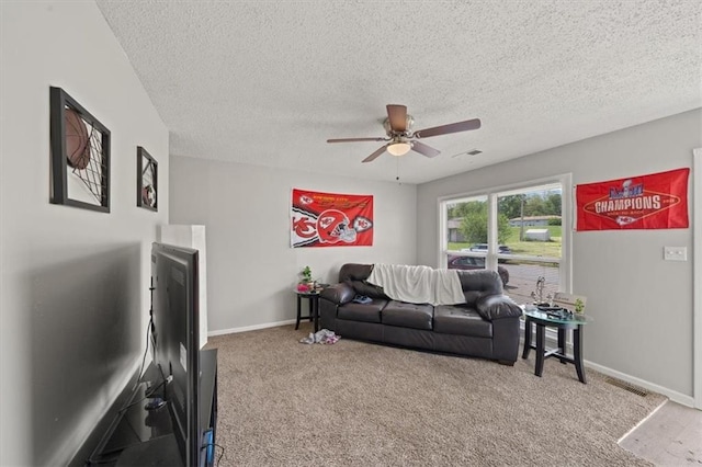 18828-30 E Wigwam Pl, Independence, MO 64056 - carpeted living room featuring a ceiling fan, baseboards, and a textured ceiling