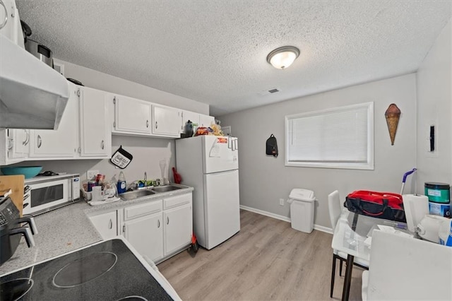 18828-30 E Wigwam Pl, Independence, MO 64056 - kitchen featuring white appliances, a sink, range hood, light wood-style floors, and white cabinets