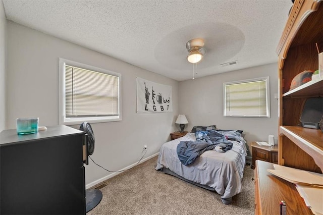 18828-30 E Wigwam Pl, Independence, MO 64056 - bedroom with carpet flooring, a textured ceiling, and ceiling fan