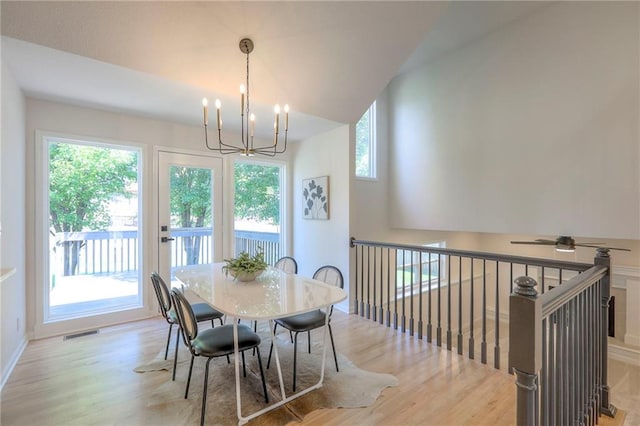 1102 Manse Dr, Raymore, MO 64083 - dining space featuring wood finished floors, a chandelier, and baseboards
