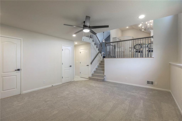 1102 Manse Dr, Raymore, MO 64083 - unfurnished living room with a ceiling fan, carpet, recessed lighting, baseboards, and a chandelier