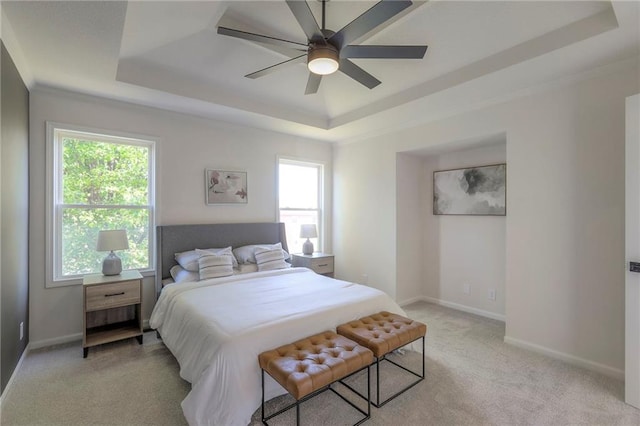 1102 Manse Dr, Raymore, MO 64083 - bedroom with a raised ceiling, light colored carpet, multiple windows, and baseboards