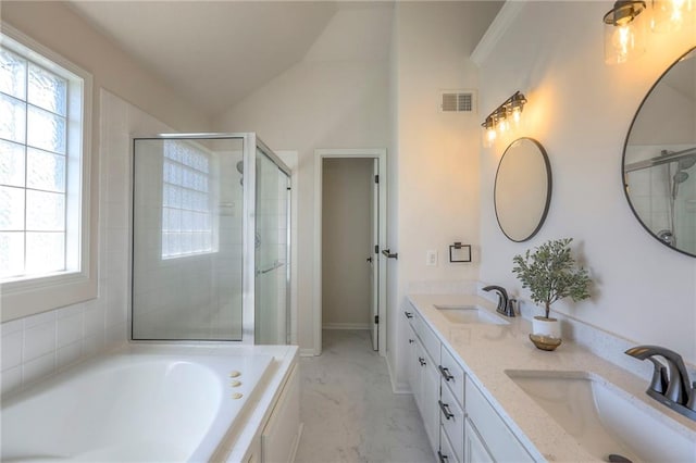 1102 Manse Dr, Raymore, MO 64083 - full bath featuring a stall shower, lofted ceiling, double vanity, a garden tub, and baseboards