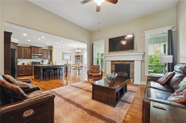 17311 Blue Moon Ln, Tonganoxie, KS 66086 - living area with plenty of natural light, light wood-style flooring, ceiling fan, a fireplace, and recessed lighting