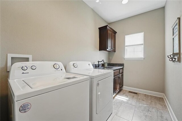 17311 Blue Moon Ln, Tonganoxie, KS 66086 - clothes washing area featuring cabinet space, washer and dryer, and baseboards