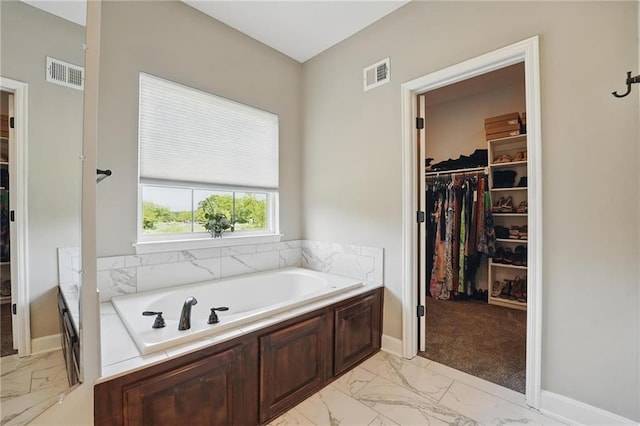 17311 Blue Moon Ln, Tonganoxie, KS 66086 - full bathroom featuring marble finish flooring, a garden tub, and a walk in closet