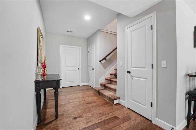 17311 Blue Moon Ln, Tonganoxie, KS 66086 - entryway featuring stairway, wood finished floors, baseboards, and recessed lighting