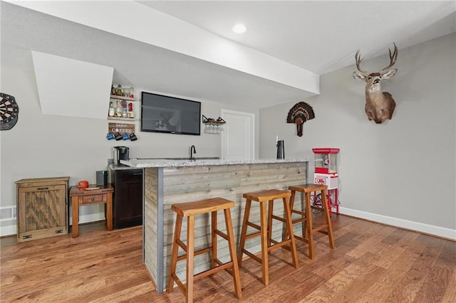 17311 Blue Moon Ln, Tonganoxie, KS 66086 - indoor wet bar featuring light wood finished floors, baseboards, and recessed lighting