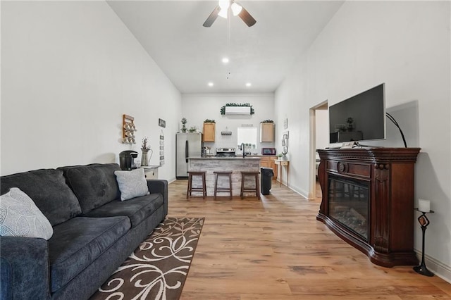 17311 Blue Moon Ln, Tonganoxie, KS 66086 - living room with light wood-type flooring, ceiling fan, and baseboards