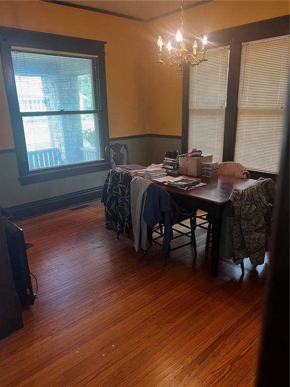315 W 4th St, Ottawa, KS 66067 - dining area featuring a chandelier and wood finished floors