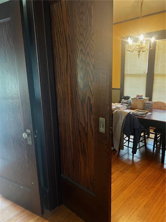 315 W 4th St, Ottawa, KS 66067 - dining space with wood finished floors and a chandelier