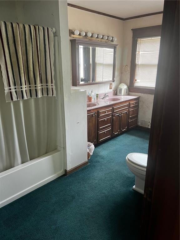 315 W 4th St, Ottawa, KS 66067 - bathroom with double vanity, toilet, shower / tub combo with curtain, carpet floors, and crown molding