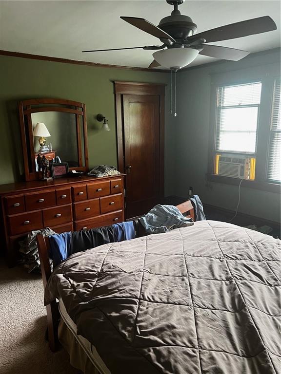 315 W 4th St, Ottawa, KS 66067 - carpeted bedroom featuring cooling unit and a ceiling fan