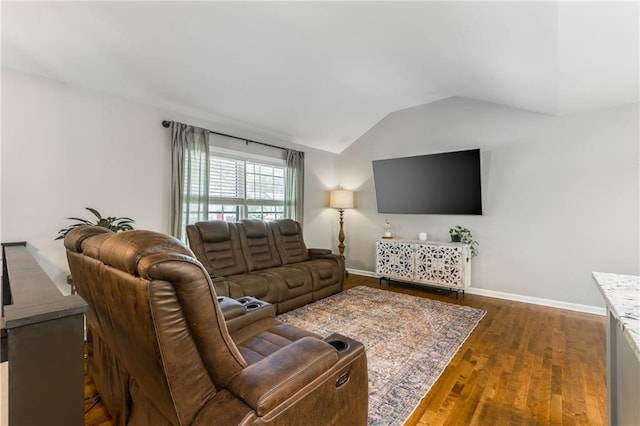 living room with vaulted ceiling, dark wood-type flooring, and baseboards