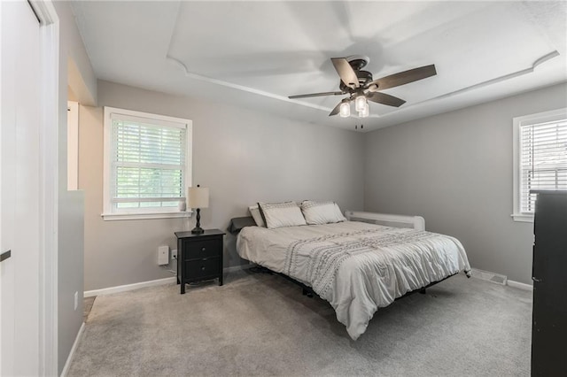 bedroom with multiple windows, baseboards, and carpet