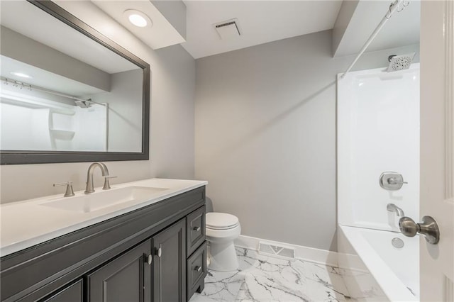 bathroom featuring marble finish flooring, baseboards, toilet, shower / washtub combination, and vanity