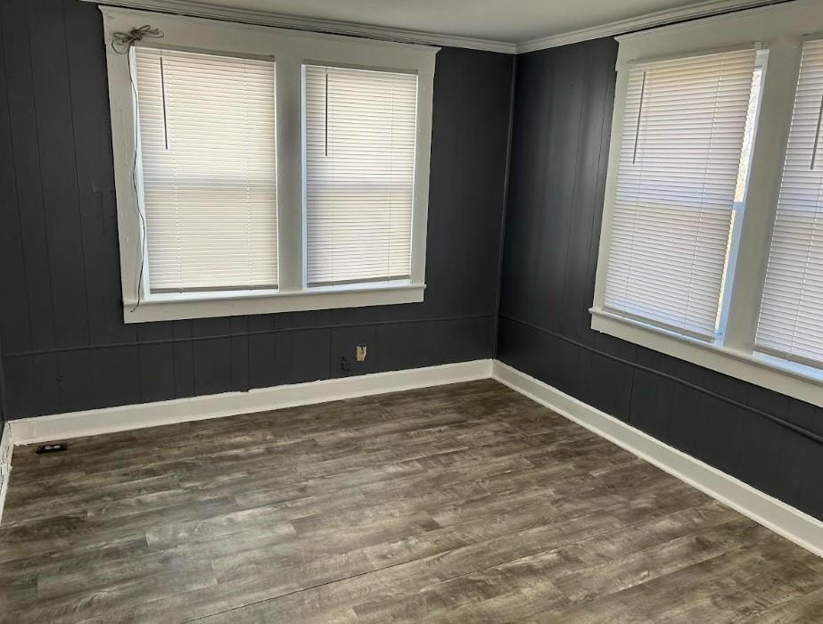 3637 Bales Ave, Kansas City, MO 64128 - unfurnished room featuring dark wood-type flooring, baseboards, and ornamental molding