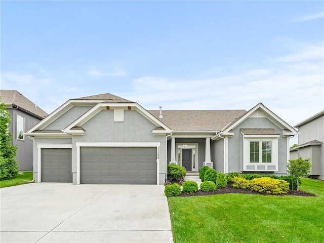 11382 S Longview Rd, Olathe, KS 66061 - single story home with concrete driveway, an attached garage, a front lawn, stucco siding, and a shingled roof