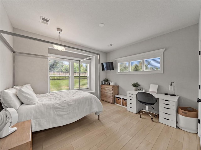 11382 S Longview Rd, Olathe, KS 66061 - bedroom with multiple windows, light wood-style floors, and a desk
