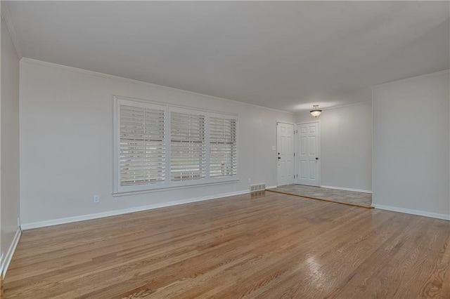 6411 Outlook Dr, Mission, KS 66202 - unfurnished living room featuring crown molding, light wood-style floors, and baseboards