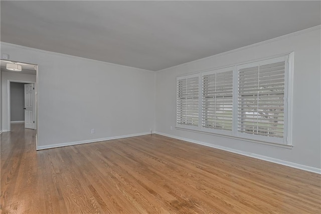 6411 Outlook Dr, Mission, KS 66202 - spare room featuring crown molding, light wood finished floors, and baseboards