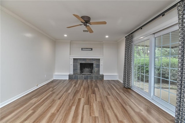 6411 Outlook Dr, Mission, KS 66202 - unfurnished living room with wood finished floors, ceiling fan, ornamental molding, baseboards, and a tiled fireplace