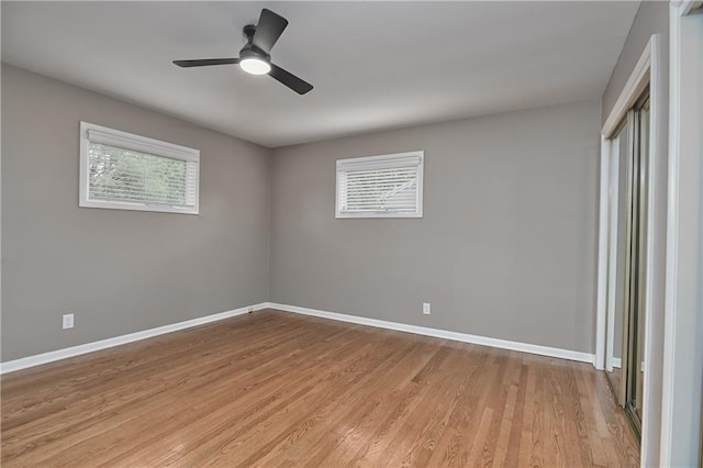 6411 Outlook Dr, Mission, KS 66202 - spare room featuring plenty of natural light, baseboards, light wood-style flooring, and ceiling fan