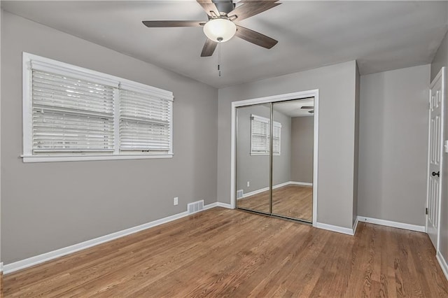 6411 Outlook Dr, Mission, KS 66202 - unfurnished bedroom with wood finished floors, a closet, baseboards, and a ceiling fan
