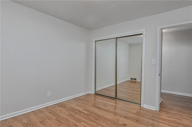 6411 Outlook Dr, Mission, KS 66202 - unfurnished bedroom featuring wood finished floors, baseboards, and a closet