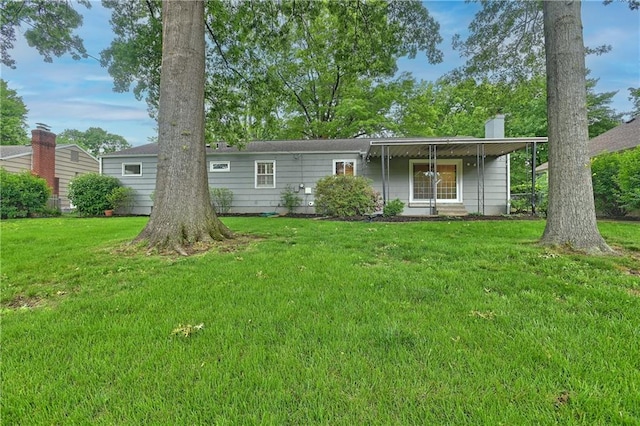 6411 Outlook Dr, Mission, KS 66202 - back of property featuring a lawn and a chimney