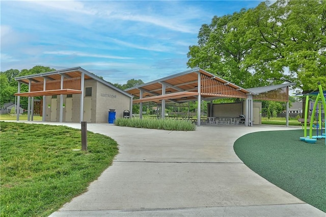 6411 Outlook Dr, Mission, KS 66202 - view of property's community featuring concrete driveway, a detached carport, and a yard