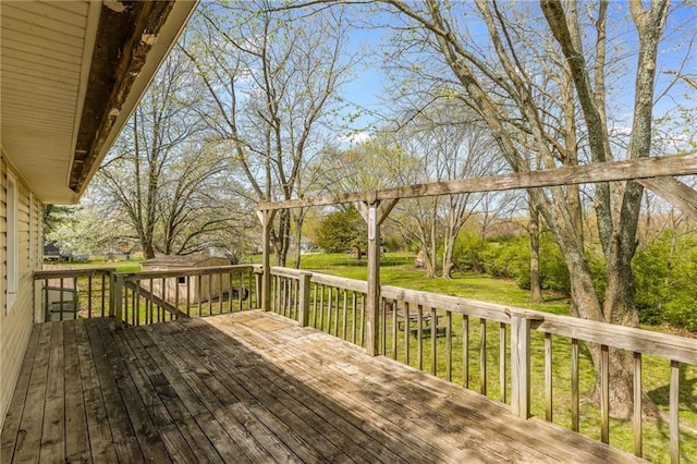 wooden terrace with a lawn