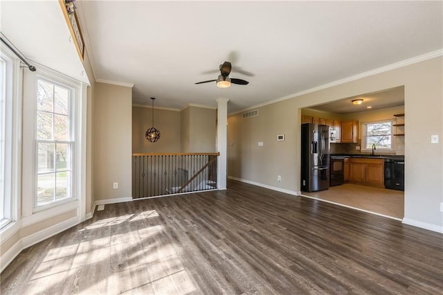 unfurnished living room featuring wood finished floors, baseboards, ornamental molding, and ceiling fan