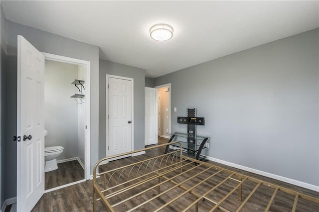 bedroom featuring baseboards and wood finished floors