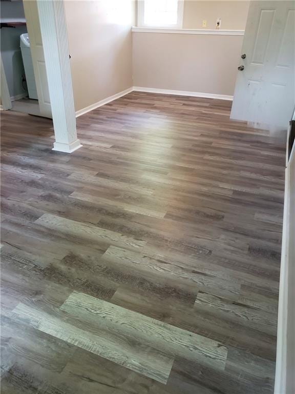 unfurnished bedroom with wood finished floors and baseboards