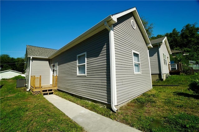 view of side of property featuring a yard and a deck