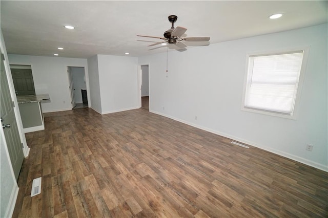 unfurnished living room featuring recessed lighting, dark wood finished floors, ceiling fan, and baseboards