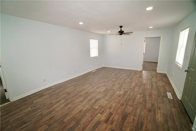 empty room featuring dark wood-type flooring, recessed lighting, ceiling fan, and baseboards