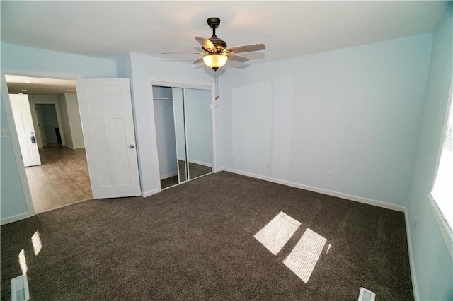 unfurnished bedroom with carpet, a closet, baseboards, and a ceiling fan
