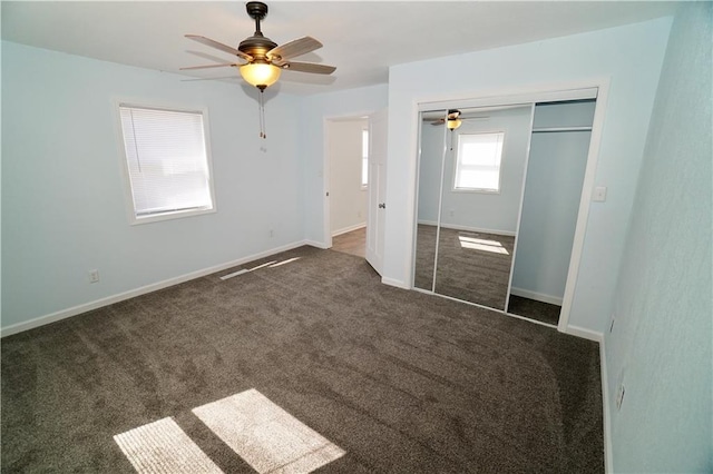 unfurnished bedroom featuring carpet flooring, a closet, baseboards, and ceiling fan