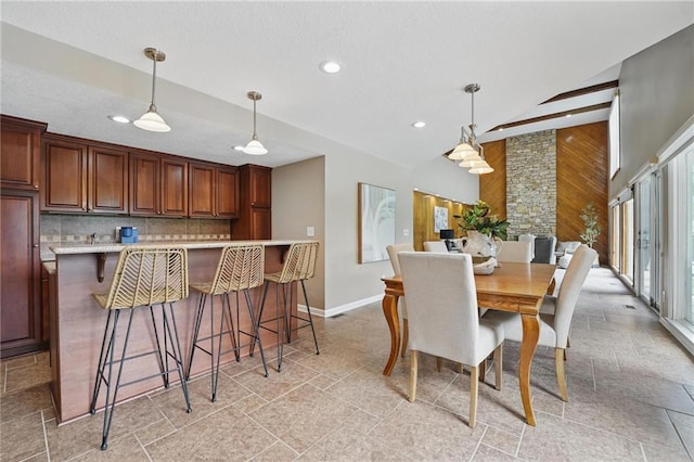 14927 S Caenen Ln, Olathe, KS 66062 - dining room featuring wooden walls, baseboards, recessed lighting, and a textured ceiling
