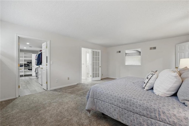 14927 S Caenen Ln, Olathe, KS 66062 - bedroom featuring carpet flooring, a walk in closet, baseboards, a textured ceiling, and connected bathroom