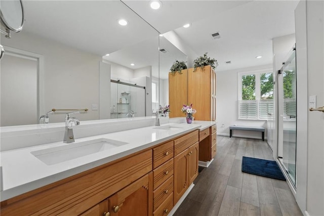 14927 S Caenen Ln, Olathe, KS 66062 - full bathroom featuring double vanity, a stall shower, wood finished floors, recessed lighting, and baseboards
